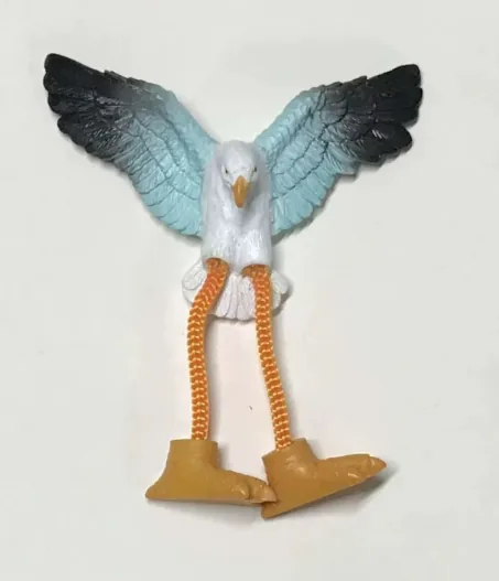 Resin souvenir magnet of a seagull with wings spread wide and dangling rope legs.