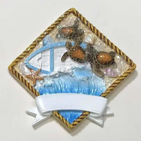 Rope-framed resin souvenir magnet of sea turtles and a sailboat, with a blank white banner.